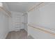 Spacious walk-in closet with built-in shelving and wood closet rods at 408 W Stallings St, Clayton, NC 27520