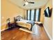 Comfortable bedroom featuring hardwood floors, natural light, and stylish furnishings at 4405 Brighton Ridge Dr, Apex, NC 27539