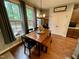 Cozy dining area with rustic table and bench seating next to multiple windows at 4405 Brighton Ridge Dr, Apex, NC 27539