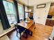 Cozy dining area with a wood table, a bench, large windows and stylish decor at 4405 Brighton Ridge Dr, Apex, NC 27539