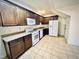 Well-lit kitchen features stainless steel appliances, warm wood cabinets, and a neutral color palette at 4405 Brighton Ridge Dr, Apex, NC 27539
