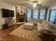 Comfortable living room featuring a stone fireplace and plush sectional sofa at 4405 Brighton Ridge Dr, Apex, NC 27539