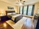 A serene main bedroom with large windows, hardwood floors, and a comfortable king-sized bed at 4405 Brighton Ridge Dr, Apex, NC 27539