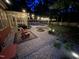 Outdoor seating area with fire pit next to screened in porch and pool at night at 4405 Brighton Ridge Dr, Apex, NC 27539