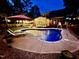 Twilight view of backyard pool, fire pit, and relaxing patio area at 4405 Brighton Ridge Dr, Apex, NC 27539