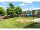 Fenced backyard featuring a wooden play set, a covered patio, and plenty of green space at 4509 Joe Cotton Dr, Knightdale, NC 27545