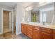 Bright bathroom featuring a double vanity with wooden cabinets, a large mirror, and a separate toilet area at 4509 Joe Cotton Dr, Knightdale, NC 27545