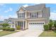 Beautiful two-story home with an attached two-car garage, attractive siding, and blue shutters at 4509 Joe Cotton Dr, Knightdale, NC 27545