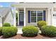 Inviting front porch with blue front door, white columns, and well-maintained landscaping at 4509 Joe Cotton Dr, Knightdale, NC 27545