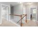 Upstairs hallway with neutral color scheme and access to other rooms at 4509 Joe Cotton Dr, Knightdale, NC 27545