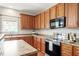 Functional kitchen area with stainless steel appliances, lots of counter space, and warm wood cabinets at 4509 Joe Cotton Dr, Knightdale, NC 27545