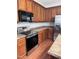 Kitchen with stainless steel oven and refrigerator with wood cabinets and countertops at 4509 Joe Cotton Dr, Knightdale, NC 27545