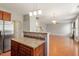 Open kitchen view with a stainless refrigerator and lots of room to access to other living areas at 4509 Joe Cotton Dr, Knightdale, NC 27545