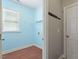 Bright laundry room featuring vinyl floors, utility sink and storage shelf at 4509 Joe Cotton Dr, Knightdale, NC 27545