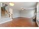 Open-concept living room boasting hardwood floors, stairs and neutral paint at 4509 Joe Cotton Dr, Knightdale, NC 27545