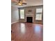 Cozy living room area featuring a fireplace, ceiling fan and hardwood floors at 4509 Joe Cotton Dr, Knightdale, NC 27545