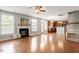 Open concept living room with fireplace, hardwood floors, and seamless flow to the kitchen at 4509 Joe Cotton Dr, Knightdale, NC 27545