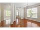 Well-lit living room with hardwood floors, large windows and a chandelier fixture at 4509 Joe Cotton Dr, Knightdale, NC 27545