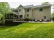 Back exterior showcasing a serene view, with a spacious deck for outdoor enjoyment and relaxation at 5025 Martin Farm Rd, Raleigh, NC 27613
