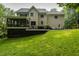 Back exterior featuring a screened porch and deck perfect for relaxing and entertaining outdoors at 5025 Martin Farm Rd, Raleigh, NC 27613