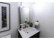 Stylish powder room featuring modern fixtures, including a gold faucet and framed mirror at 5025 Martin Farm Rd, Raleigh, NC 27613