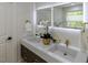 Bathroom featuring double sinks, modern lighting and gold hardware at 5025 Martin Farm Rd, Raleigh, NC 27613