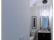Powder room featuring a modern vanity with a framed mirror and stylish pendant lighting at 5025 Martin Farm Rd, Raleigh, NC 27613