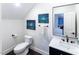 Modern bathroom with a clean aesthetic, featuring a sleek vanity, toilet, and stylish mirror at 5025 Martin Farm Rd, Raleigh, NC 27613