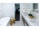 Bright bathroom features a double sink vanity, soaking tub, and doorway to the Primary bedroom at 5025 Martin Farm Rd, Raleigh, NC 27613