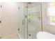 Bathroom featuring a glass shower with white subway tile and gray accent tile at 5025 Martin Farm Rd, Raleigh, NC 27613