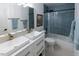 Bathroom featuring double sinks, a shower/tub combination with tile surround at 5025 Martin Farm Rd, Raleigh, NC 27613