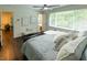 Cozy bedroom featuring large windows, hardwood floors, and a door that leads to another room at 5025 Martin Farm Rd, Raleigh, NC 27613