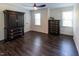 Bedroom featuring dark wood floors, windows, and black wood furniture at 5025 Martin Farm Rd, Raleigh, NC 27613