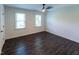 Bright bedroom featuring wood-look floors and large windows with natural light at 5025 Martin Farm Rd, Raleigh, NC 27613