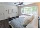 This cozy bedroom features dark wood-look floors, a large window, and a comfortable queen bed at 5025 Martin Farm Rd, Raleigh, NC 27613