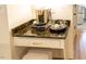 Close-up of granite counter with coffee station featuring a stylish coffee maker and complementing decor at 5025 Martin Farm Rd, Raleigh, NC 27613