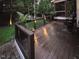 Inviting wooden deck with garden views and ambient lighting at 5025 Martin Farm Rd, Raleigh, NC 27613