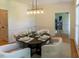 A dining room with a modern chandelier and hardwood floors at 5025 Martin Farm Rd, Raleigh, NC 27613