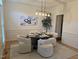 Stylish dining room boasts modern lighting, contemporary art, and seating for four in a bright space at 5025 Martin Farm Rd, Raleigh, NC 27613