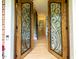 Elegant entryway with decorative wood and glass doors leading to the home's interior staircase at 5025 Martin Farm Rd, Raleigh, NC 27613