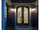Elegant front door with intricate ironwork and decorative lighting at 5025 Martin Farm Rd, Raleigh, NC 27613