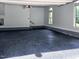 Spacious two-car garage with epoxy floors, natural light, and ample space for parking and storage at 5025 Martin Farm Rd, Raleigh, NC 27613