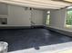 Clean garage with epoxy flooring and natural light from windows at 5025 Martin Farm Rd, Raleigh, NC 27613