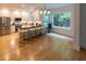 Bright kitchen with large windows, stainless steel appliances, and island with barstool seating at 5025 Martin Farm Rd, Raleigh, NC 27613