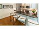 Kitchen featuring island seating with stone countertops, stainless steel appliances and hardwood floors at 5025 Martin Farm Rd, Raleigh, NC 27613