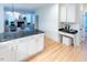Kitchen island with marble countertops and storage, with view to living room with fireplace at 5025 Martin Farm Rd, Raleigh, NC 27613