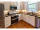 Well-lit kitchen features stainless steel appliances, granite countertops, and a stone backsplash at 5025 Martin Farm Rd, Raleigh, NC 27613