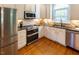 Charming kitchen featuring stainless steel appliances, stylish countertops, and stone backsplash at 5025 Martin Farm Rd, Raleigh, NC 27613