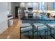 Bright kitchen with granite countertops, stainless steel appliances, island, and breakfast bar with seating at 5025 Martin Farm Rd, Raleigh, NC 27613