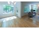 Bright living area with hardwood floors and large windows showcasing a beautiful outdoor view at 5025 Martin Farm Rd, Raleigh, NC 27613